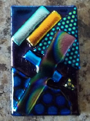 abstract pin or pendant handcrafted in dichroic glass in the USA