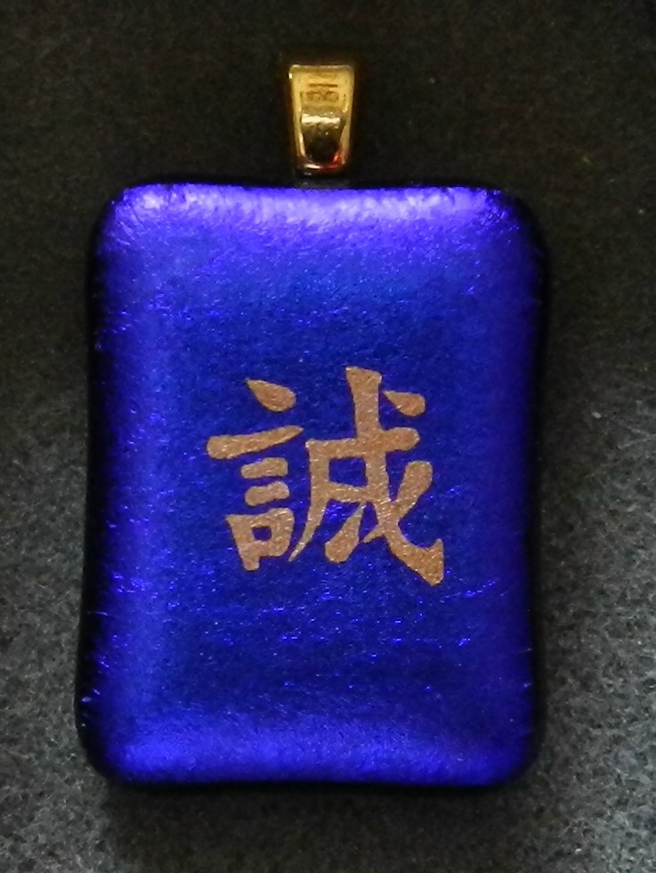 Dichroic glass pendant featuring gold chinese character for honesty in gold