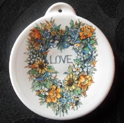 pottery ornament with floral wreath and Love decal